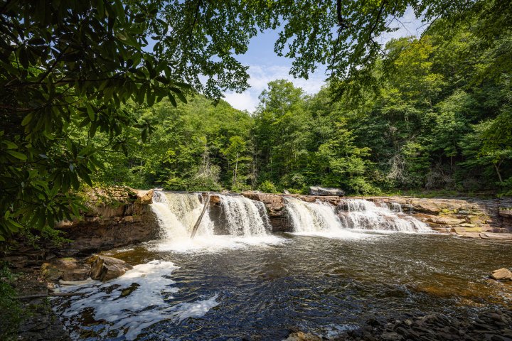 a large waterfall over a body of water
