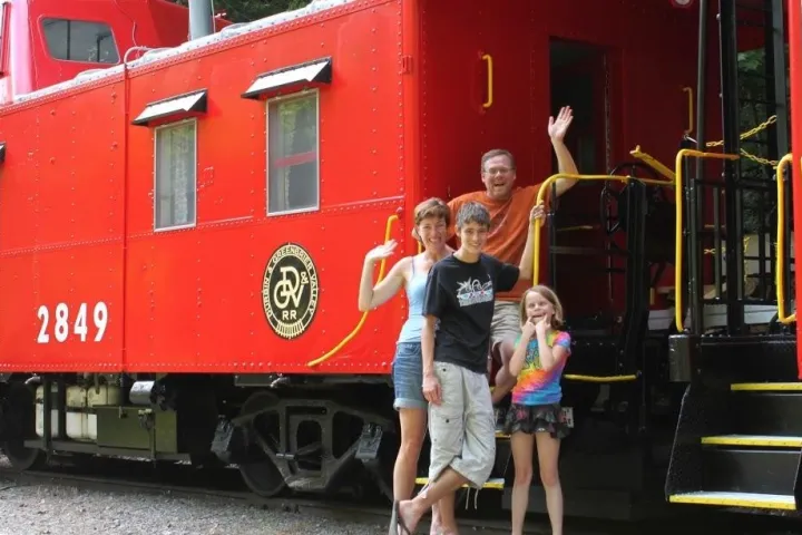 a person standing next to a train