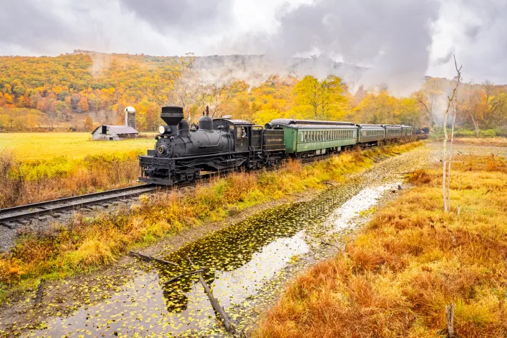 a train on a track with smoke coming out of it