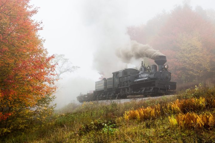 a train on a track with smoke coming out of it