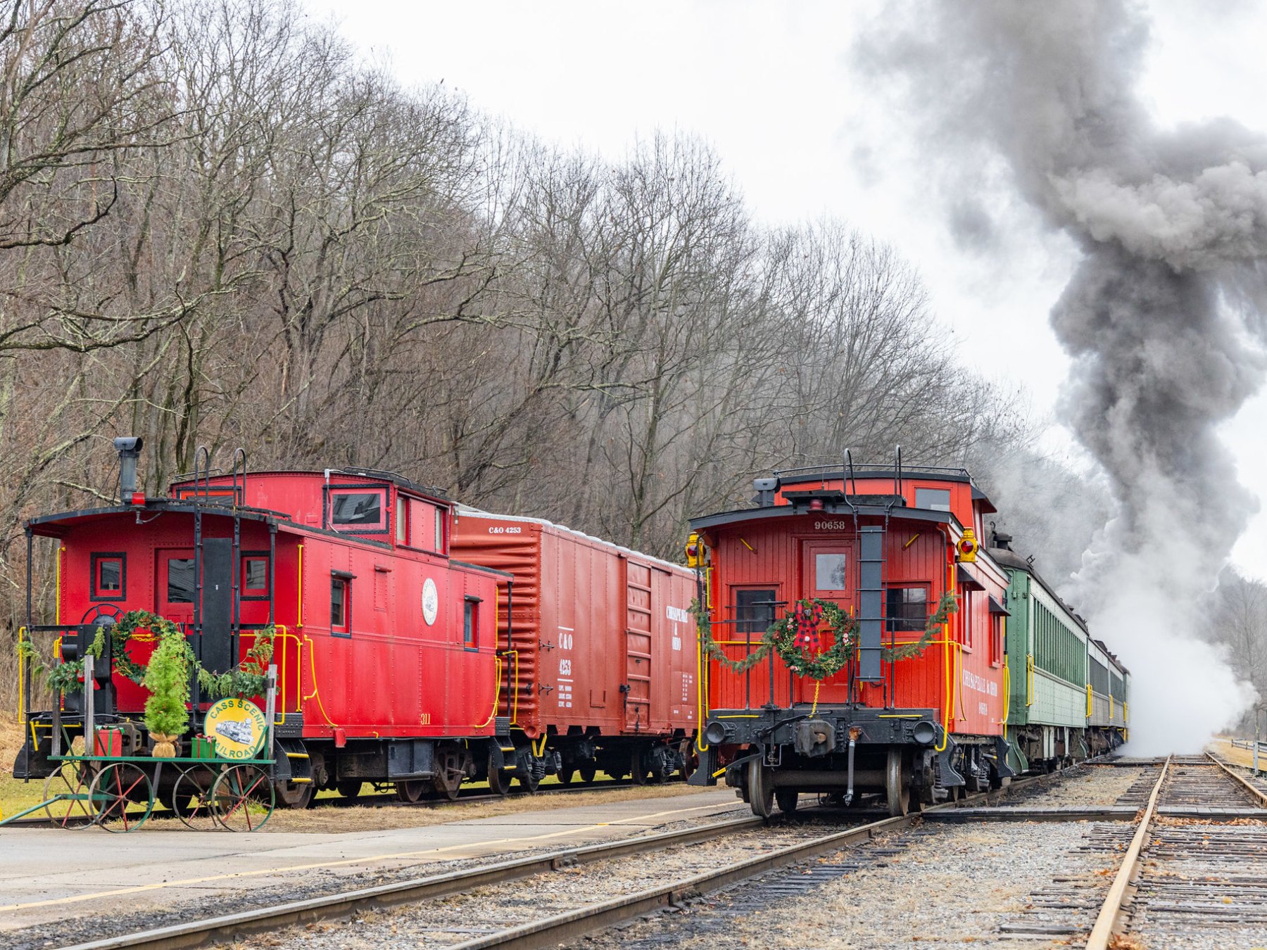 a large long train on a track with smoke coming out of it
