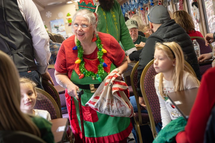 a group of people sitting in a chair talking on a cell phone