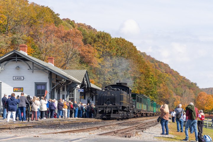 a group of people standing next to a train
