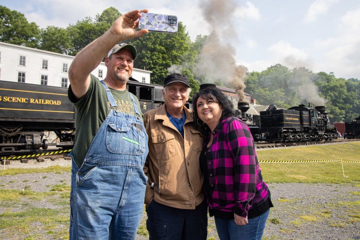 a man standing on top of a grass covered field