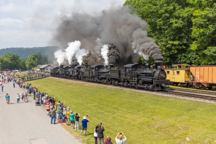 a steam train on a track with smoke coming out of it