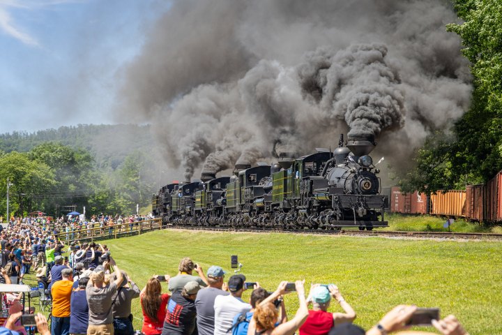 a steam train on a track with smoke coming out of it