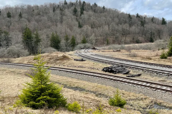a train traveling down a dirt road