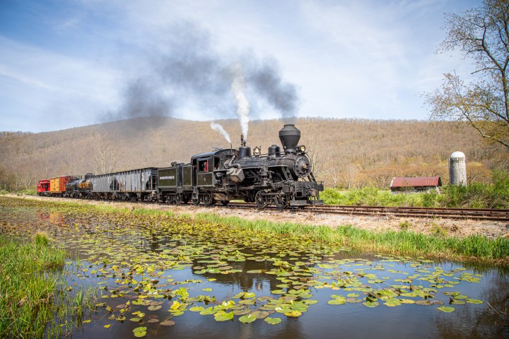 a train on a track with smoke coming out of it